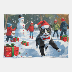 Tuxedo Cat Running in Snow with Christmas Hat Tea Towel