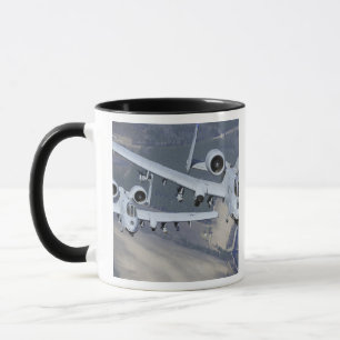 Two A-10C Thunderbolt II aircraft fly in format Mug