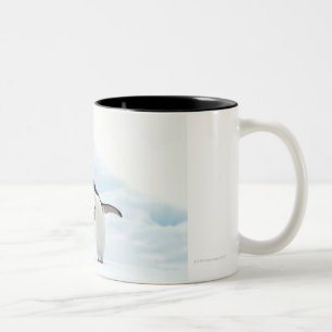 Two Adelie Penguins sitting on a sheet of ice Two-Tone Coffee Mug