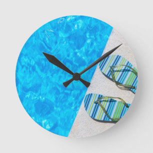 Two bathing slippers on edge of swimming pool round clock