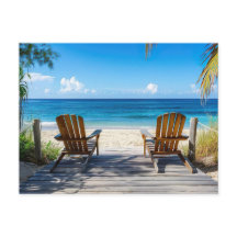 Two beach chairs on a wooden pontoon facing the se