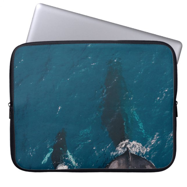 TWO BLACK WHALES SWIMMING IN BODY OF WATER LAPTOP SLEEVE (Front)