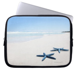 Two blue starfish at water's edge on tropical 2 laptop sleeve