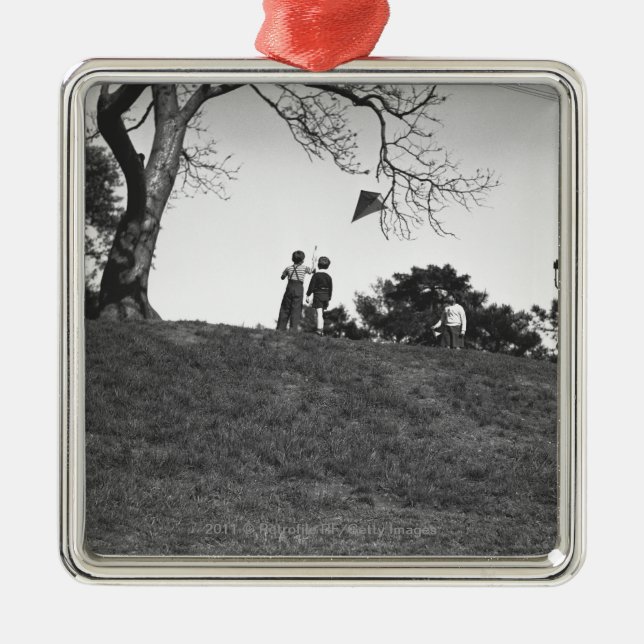 Two boys flying kite on hill B&W Metal Tree Decoration (Front)