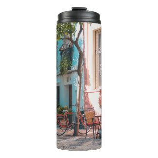 Two brown table outside thermal tumbler