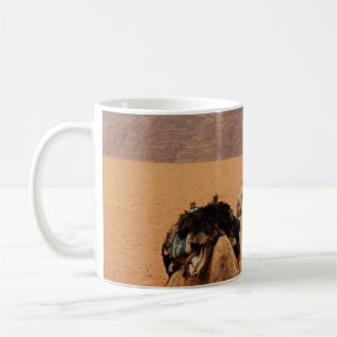 TWO CAMEL SITTING ON BROWN SAND NEAR MOUTAINS COFFEE MUG