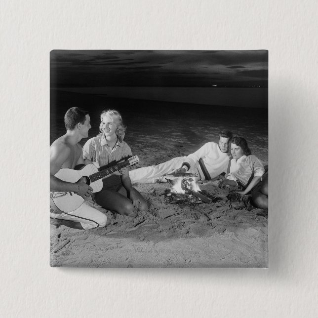 Two couples on beach sitting around campfire 15 cm square badge (Front)