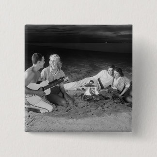 Two couples on beach sitting around campfire 15 cm square badge