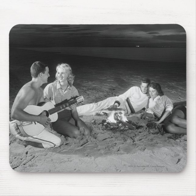 Two couples on beach sitting around campfire mouse mat (Front)