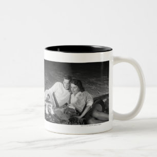 Two couples on beach sitting around campfire Two-Tone coffee mug