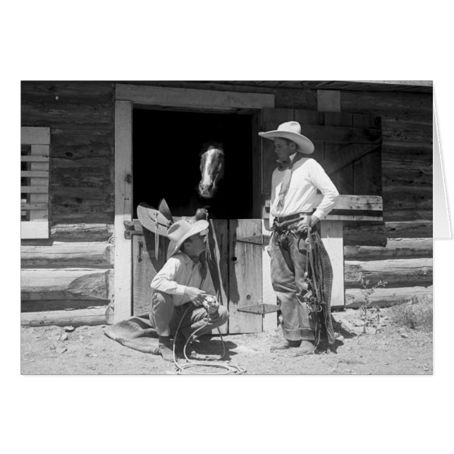 Two cowboys standing next to a barn with a horse (Front Horizontal)