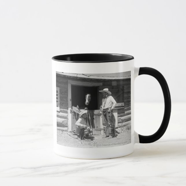 Two cowboys standing next to a barn with a horse mug (Right)