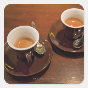 two cups of freshly brewed espresso coffee on a square sticker