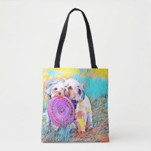 Two cute dogs playing frisbee tote bag
