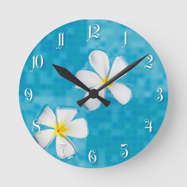 Two frangipani flowers in a blue water round clock (Front)