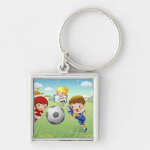 Two girls and a boy playing soccer key ring