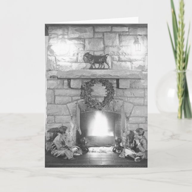 Two girls sitting by a fireplace at Christmas Holiday Card (Front)