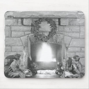 Two girls sitting by a fireplace at Christmas Mouse Mat