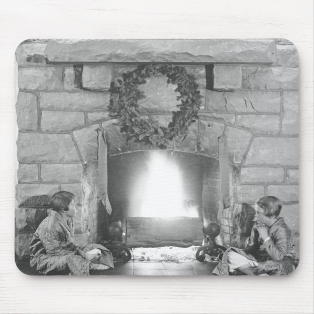 Two girls sitting by a fireplace at Christmas Mouse Mat (Front)