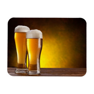 Two glasses of beers on a wooden table magnet