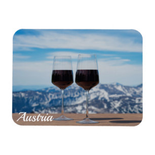 Two glasses of red wine against mountains magnet