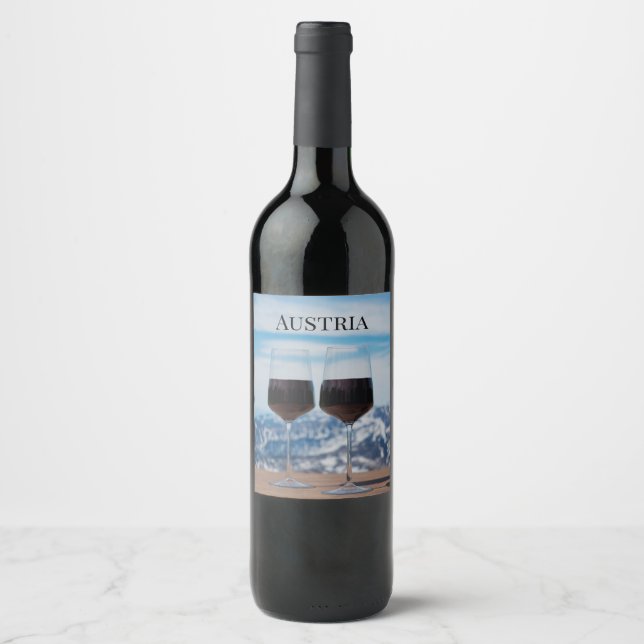 Two glasses of red wine against mountains wine label (Front)