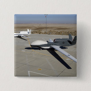 Two Global Hawks parked on a ramp 15 Cm Square Badge
