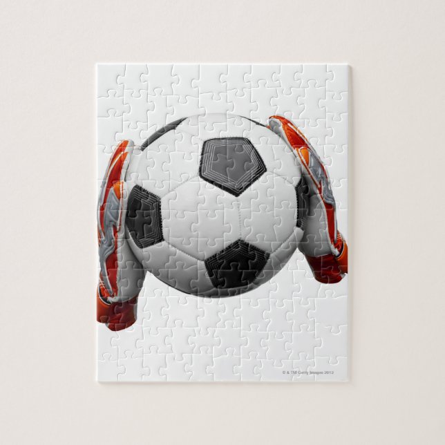 Two goal keepers gloves holding a football jigsaw puzzle (Vertical)