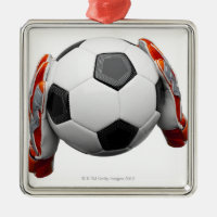 Two goal keepers gloves holding a football