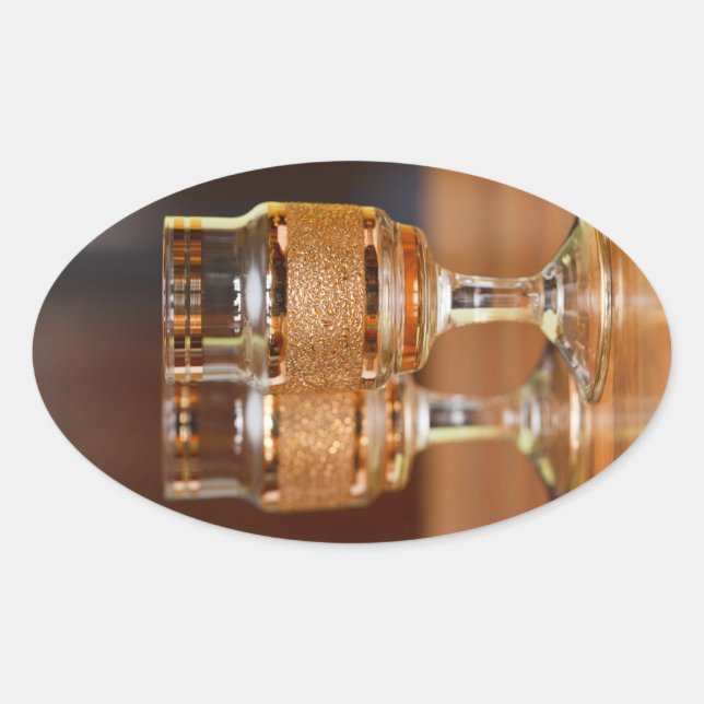 Two Golden Glasses Oval Sticker (Front)