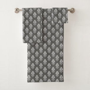 Two grey towels with white intricate floral