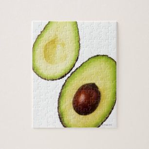 Two halves of an an avocado, on white jigsaw puzzle