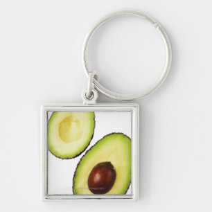 Two halves of an an avocado, on white key ring