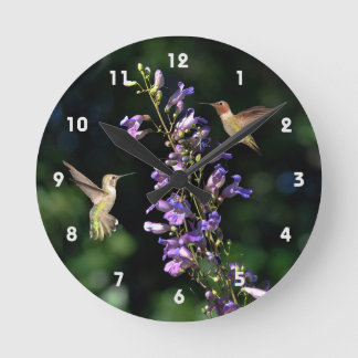 Two Hummingbirds In Flight With Flowers Wall Clock