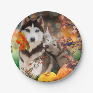 Two husky dogs, a garden cart and pumpkins	 paper plate
