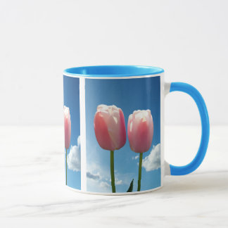 two lovely pink tulip flowers in blue sky. flower mug