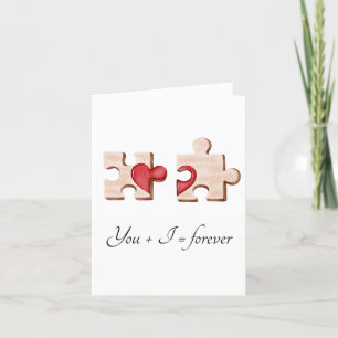 two matching puzzle pieces with a red heart Card