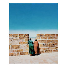 Two Men Gazing Over Wall Towards Bright Blue Sky