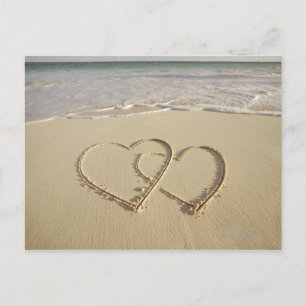 Two overlying hearts drawn on the beach postcard