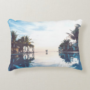 Two person standing beside swimming pool decorative cushion