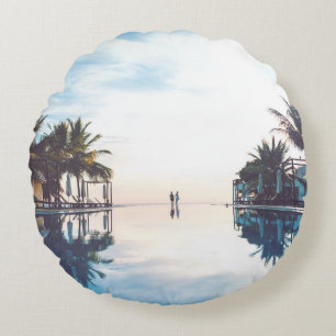 Two person standing beside swimming pool round cushion