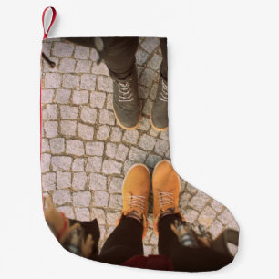Two person standing in front each other photo small christmas stocking
