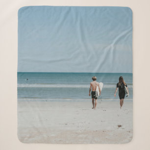 Two person walking on coast sherpa blanket