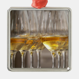 two rows of wine tasting glasses with lucious metal tree decoration