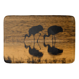 Two Silhouetted Cranes Bath Mat