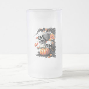 Two skulls and a pumpkin among flowers. frosted glass beer mug
