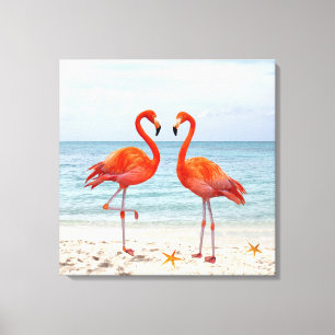 Two Vibrant Pink Flamingos on the Beach Canvas Print