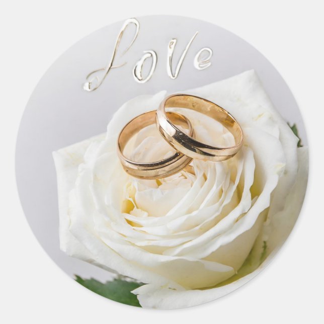 Two wedding rings on a white rose  classic round sticker (Front)