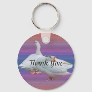 two white geese in fancy background. thank you key ring