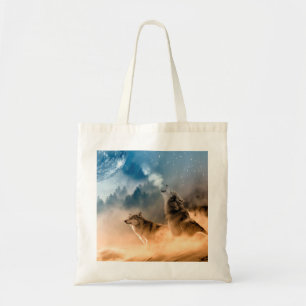 Two wolves howl at the full moon in forest tote bag